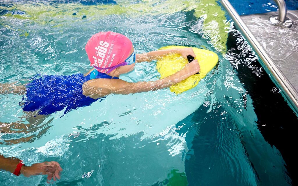 A kid taking swimming lessons at SwimLabs